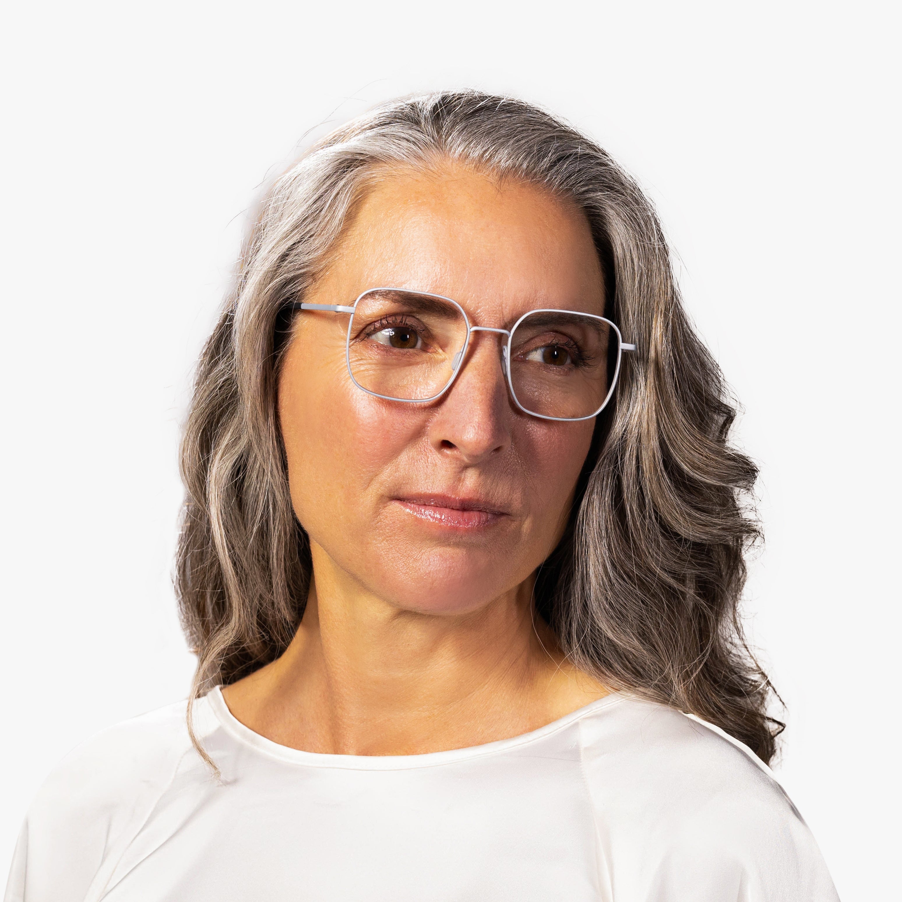 Person wearing Båstad Steel glasses with clear lenses and silver frames