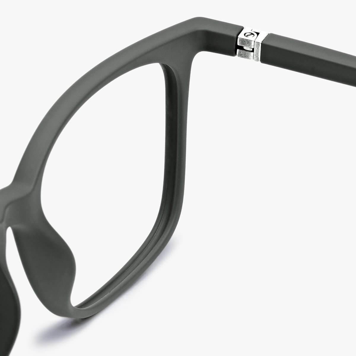 Close-up of Fyn Dark Army glasses with dark matte frame and silver hinge detail