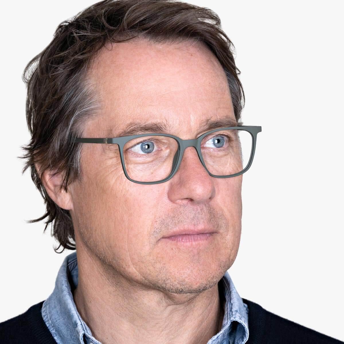 Person wearing Fyn Dark Army square glasses