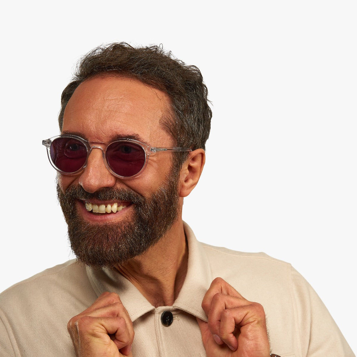 Person wearing round crystal reading glasses with red lenses