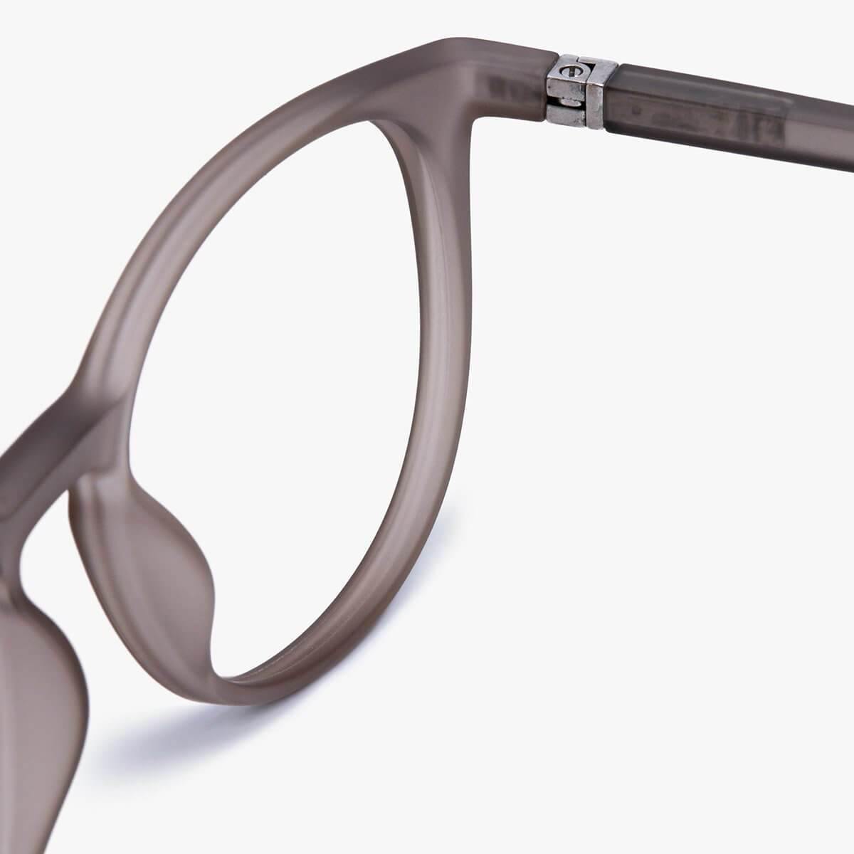 Close-up of grey round eyeglass frame with metal hinge